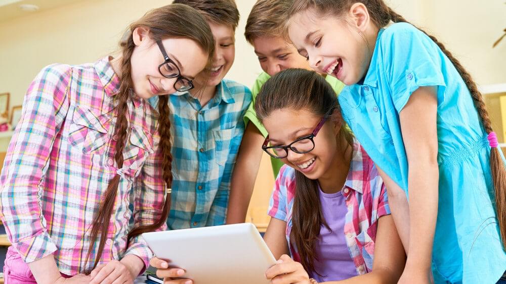 Children looking at device for education